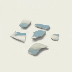A shattered glass fragment against a serene blue sky.